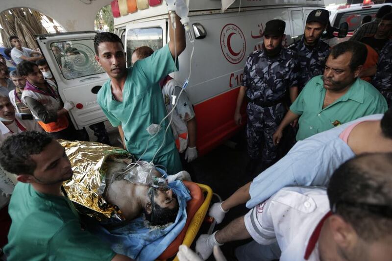 File picture of Palestinian medics pushing a wounded man injured from an Israeli strike in Shujaieh neighbourhood, into the emergency room at Gaza City’s Shifa hospital taken on July 30, 2014 during the summer war. Lefteris Pitarakis/AP Photo