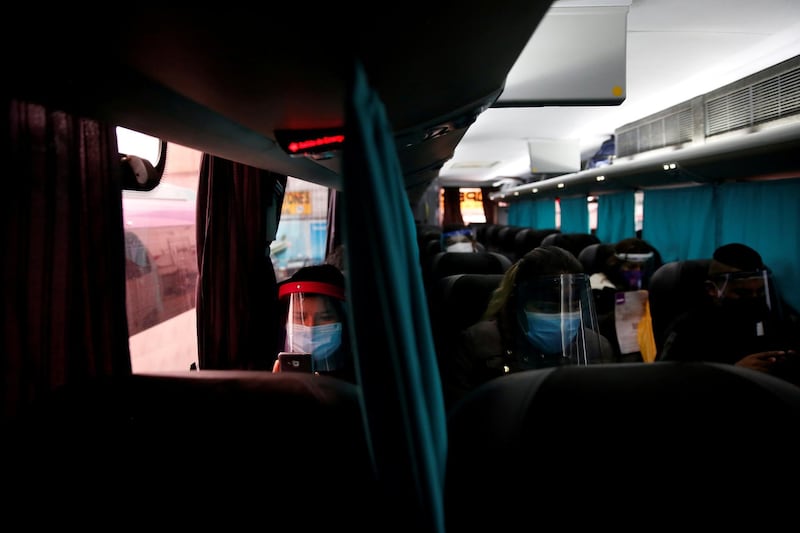 Passengers sit, separated from their neighbours by a curtain, on a bus amid the coronavirus pandemic, in Lima, Peru. Reuters