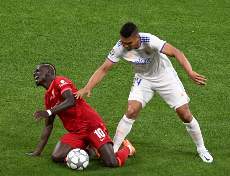 Liverpool's Sadio Mane reacts to a challenge from Real midfielder Casemiro. EPA