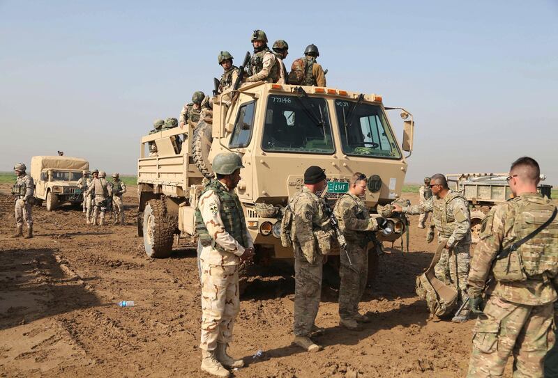 FILE - In this Sunday, Jan. 24, 2016 file photo, Iraqi soldiers participate in a training exercise with American and Spanish trainers, which includes live ammunition, at Basmaya base, 40 kilometers southeast of Baghdad, Iraq. The U.S. and Iraq launched much-anticipated strategic talks on Thursday, June 11, 2020, spanning the gamut of bilateral relations with Washington prioritizing the future of its forces in the country, and Baghdad, a dire economic crisis. But the outcome of discussions will be months away, U.S. and Iraqi officials said. (AP Photo/Karim Kadim, File)