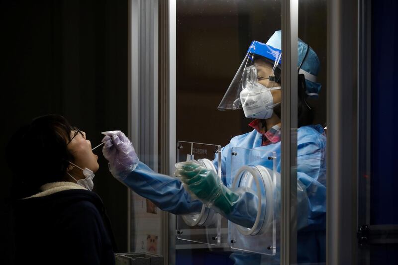 A woman undergoes a coronavirus disease test at a testing site in Seoul, South Korea. Reuters