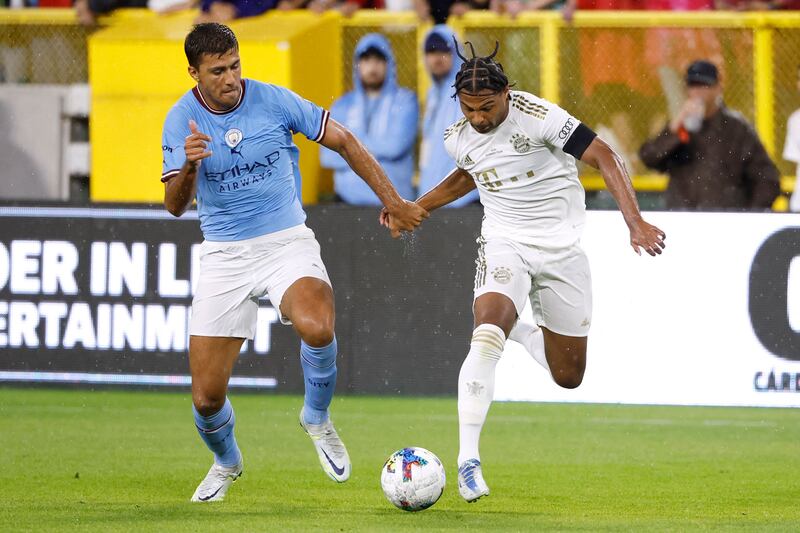 Manchester City midfielder Rodrigo vies for the ball with Bayern Munich winger Serge Gnabry. AFP