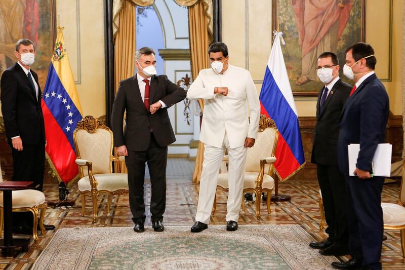 Venezuela's President Nicolas Maduro and Russia's ambassador in Venezuela Sergey Melik-Bagdasarov, touch their elbows while wearing masks due to coronavirus disease while (COVID-19) outbreak at Miraflores Palace in Caracas, Venezuela. REUTERS