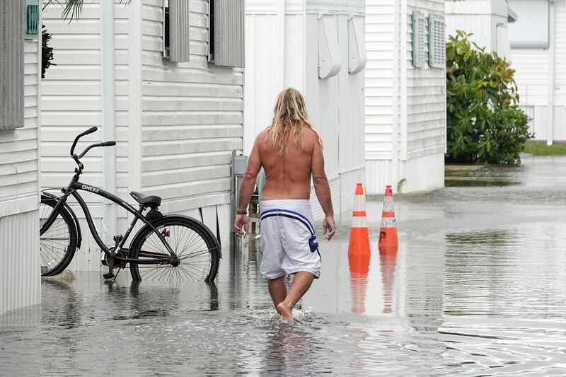 A resident walks through flooding caused by the rain bands of Hurricane Nicole in Briny Breezes, Florida. AP
