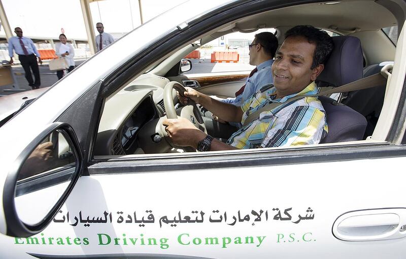 Kader Batcha, an expatriate from India, is instructed by Naeem Khan at the Emirates Driving Company in Mussaffah. Christopher Pike / The National
