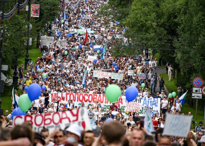 People hold various posters supporting Khabarovsk region's governor Sergei Furgal, during a protest in support of Sergei Furgal, who was interrogated and ordered to be held in jail for two months, in Khabarovsk, Russia  AP