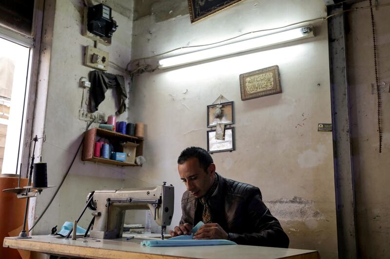 Ali Sarsour uses a sewing machine at his home in Amman. Reuters