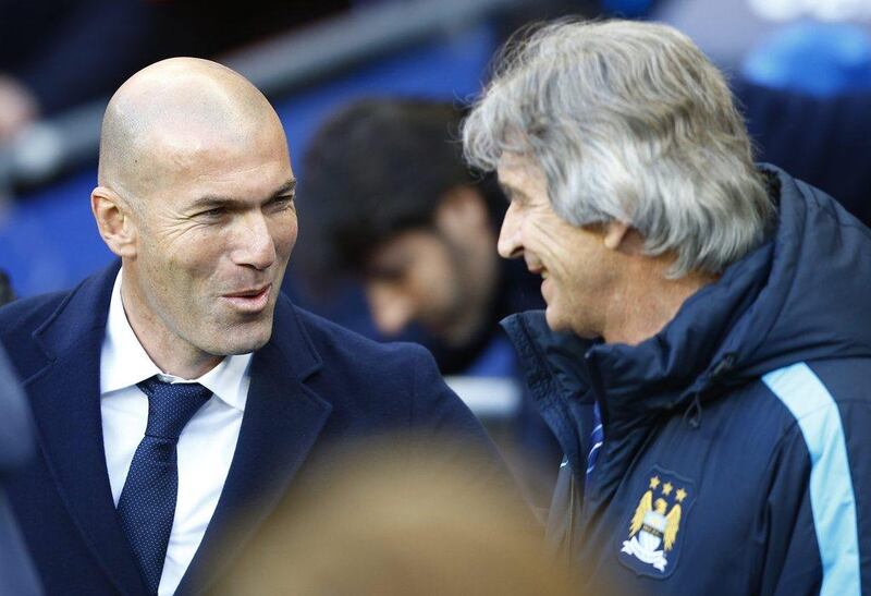 Real Madrid coach Zinedine Zidane and Manchester City manager Manuel Pellegrini before the game. Darren Staples / Reuters