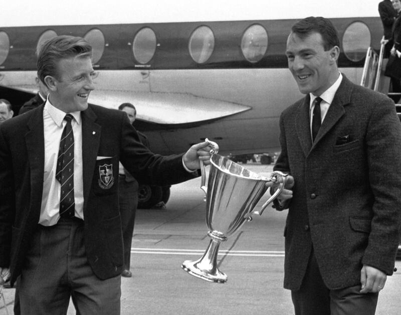 Greaves and Terry Dyson carry the European Cup Winners Cup at London's Heathrow Airport after beating Atletico Madrid in 1963. AP