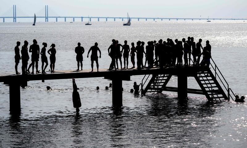 People enjoy a swim on a hot summer day in Malmo, southern Sweden. AFP