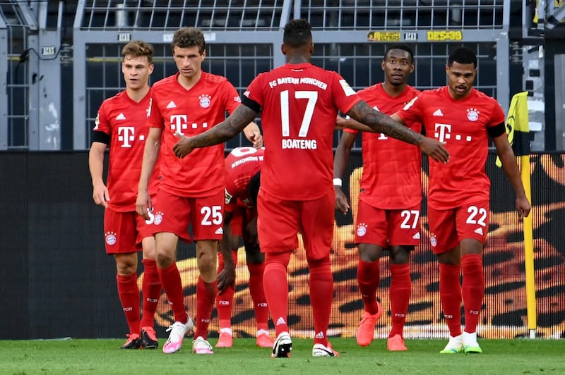 Bayern players celebrate taking the lead against Dortmund. EPA