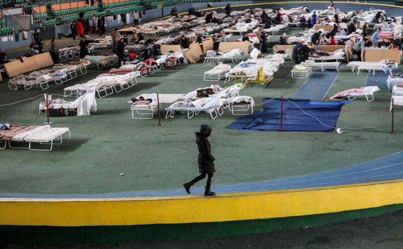 A woman walks on the track of an athletics complex that has been turned into a refugee shelter in Chisinau, Moldova. AFP