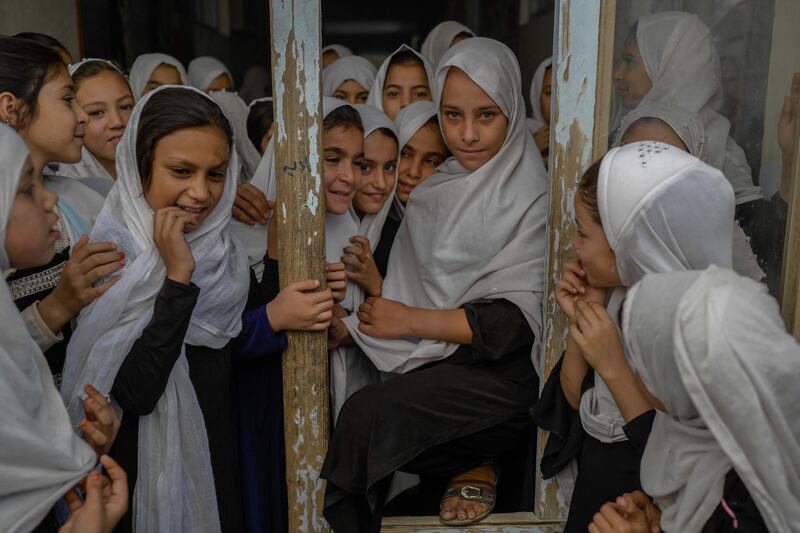 Afghan girls step out of their classes in a school in Kandahar.  AFP