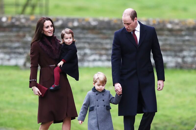Prince George and Princess Charlotte arrive with their parents to attend a service at St Mark's Church on Christmas Day in 2016 in Bucklebury, Berkshire. 