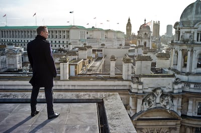 Daniel Craig as James Bond in 'Skyfall' with the Old War Office building in the background. Alamy