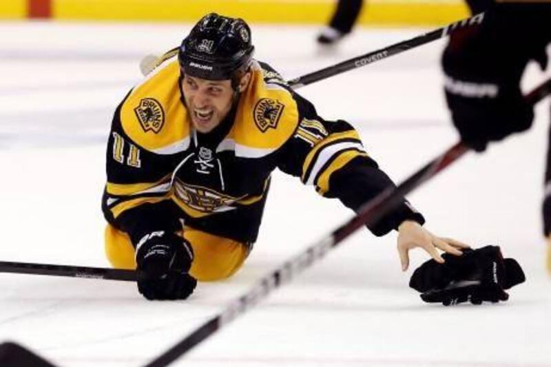 Boston Bruins’ Gregory Campbell broke his leg after he was hit by a shot but stayed in the game. Bruce Bennett / AFP
