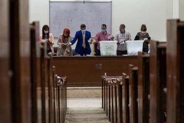 Election officials wearing face masks count ballots following the first round of Egypt's parliamentary elections in Giza, Egypt. EPA