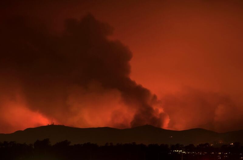 A wildfire burns on the hills of Ventura County as night falls and the winds calm near Ventura, California. Mike Blake / Reuters