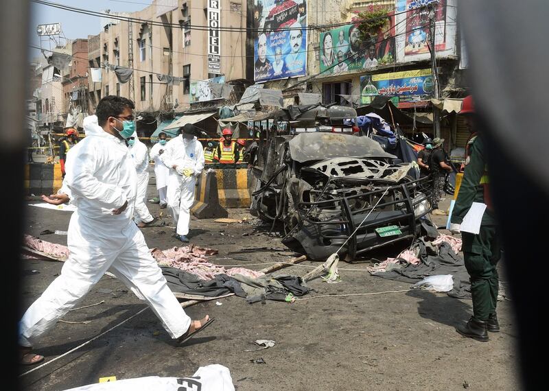 Officials examine the site of the bomb blast. AFP