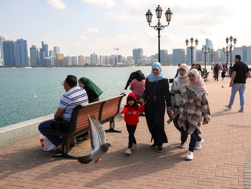 Families along the Corniche in Abu Dhabi on the first morning of 2023. Victor Besa / The National