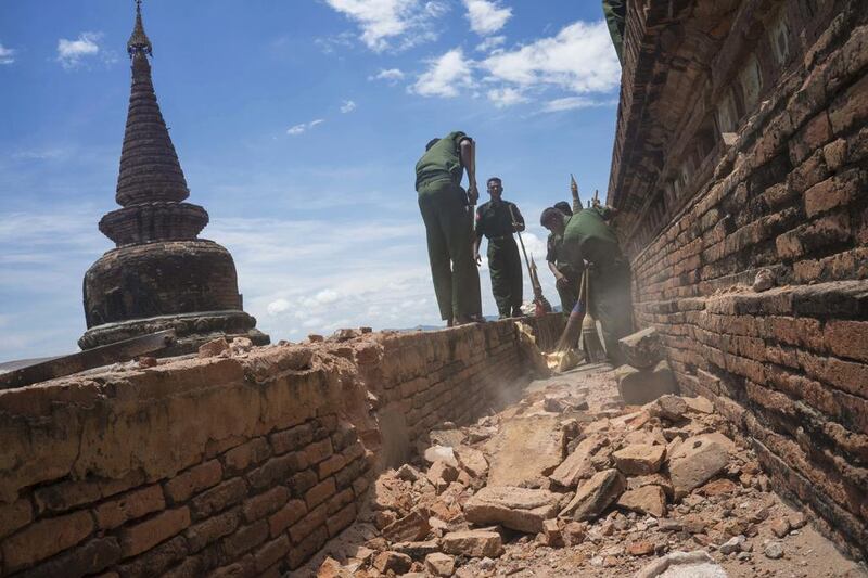 Military personnel clear debris at a temple that was damaged by a strong earthquake in Bagan, Myanmar on August 25, 2016. Two young girls and a man died in Magway region where the 6.8 magnitude quake struck. Hkun Lat/AP Photo