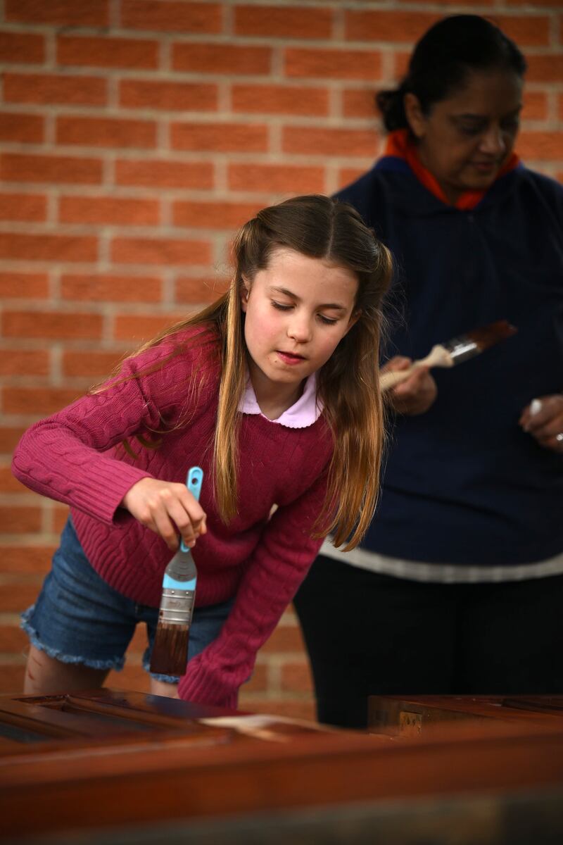 Princess Charlotte stains some wood. Getty
