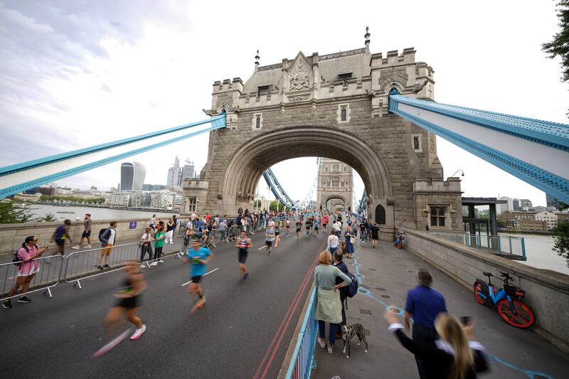 Runners cross Tower Bridge in London during a half marathon. PA