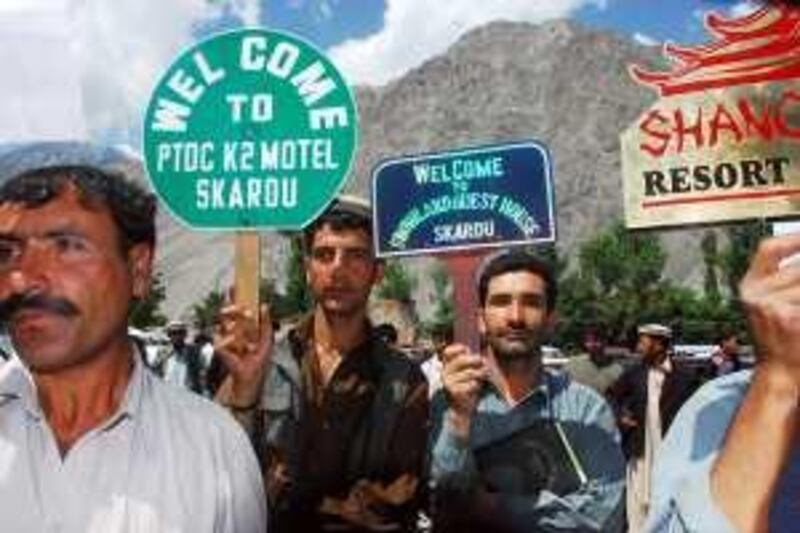 Local hotel workers advertise their businesses at the Skardu airport, in the tourist district of Gilgit by holding promotional sign posts.Hoteliers in area have seen their businesses, which form the mainstay of the regional economy, have collapsed because of generalised diplomatic and media terminology that describes the insurgency wracked districts of the Northwest Frontier Province and tribal agencies bordering Afghanistan as “northern areas”.Baltistan, Pakistan, Saturday, June 20th, 2009. (The National/Matthew Tabaccos)
