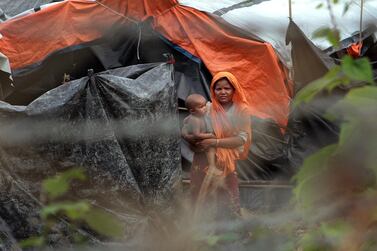 Rohingya refugees look out from their camp near a fence in a no-man's land between Myanmar and Bangladesh, near Taungpyolatyar village, Maung Daw, northern Rakhine State, Myanmar. Min Kyi Thein / AP 