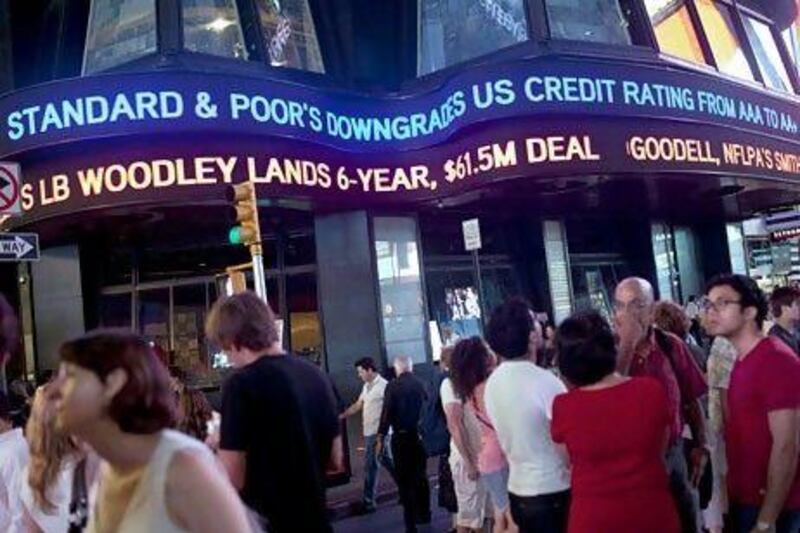 An ABC News ticker reads "Standard & Poor's downgrades US credit rating from AAA to AA+" in Times Square in New York City. The ratings agency decided to downgrade the US credit rating after the prolonged debt-limit debate in the US government. Andrew Burton/Getty Images/AFP