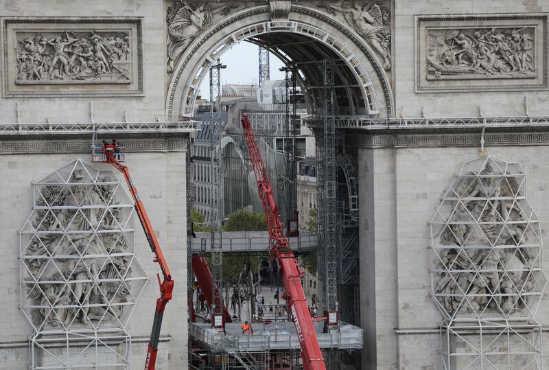 Workers are preparing the famed Paris monument for the project called 'L'Arc de Triomphe, Wrapped' by late artist Christo who wished this project to be continued after his death. AP