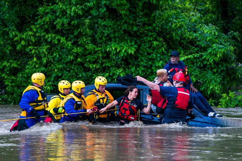 Commuters are rescued from a flooded car on Columbia Pike after a flash flood in Oakland Mills, Maryland, USA, 27 May 2018. The National Weather Service stated as much as 9.5 inches of rain fell in the area.  Jim Lo Scalzo / EPA