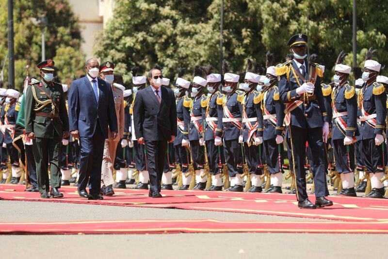 Sudan's Sovereign Council Chief General Abdel Fattah al-Burhan walks with Egyptian President Abdel Fatah al-Sisi, during a welcome ceremony in Khartoum, Sudan March 6, 2021. Sudan Sovereign Council/Handout via REUTERS ATTENTION EDITORS - THIS IMAGE WAS PROVIDED BY A THIRD PARTY.