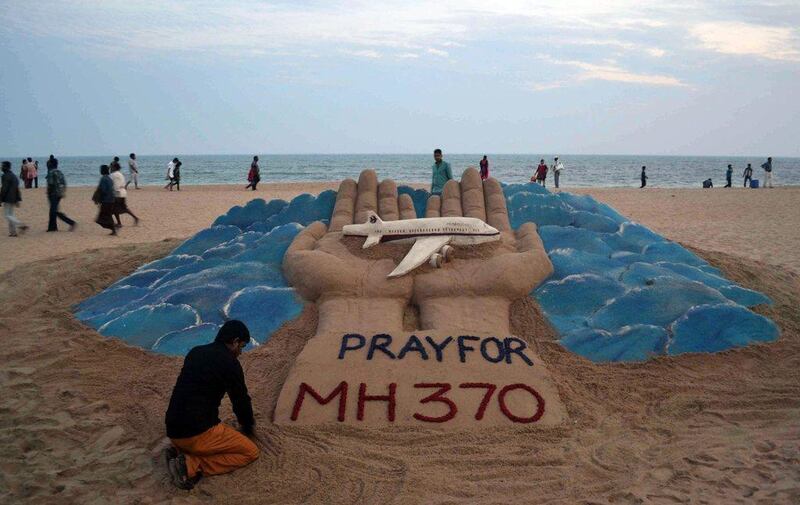 Sand artist Sudarshan Pattnaik creates a sculpture depicting the missing Malaysian Airlines aircraft on the beach in Puri, India. AP Photo