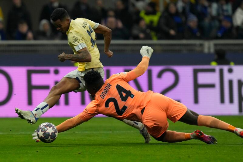 Inter goalkeeper Andre Onana and Porto's Galeno reach for the ball. AP