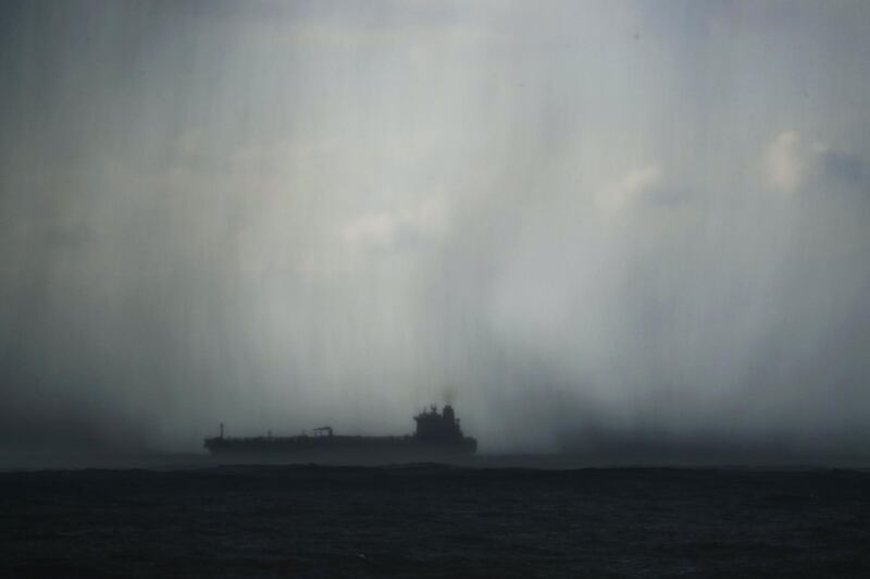 A ship sails under heavy rainfall off the shore of the town of Naameh, south of the Lebanese capital Beirut. AFP