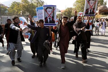 Protesters hold placards as they chant slogans during a protest against the French President Emmanuel Macron in Kabul last week. Reuters