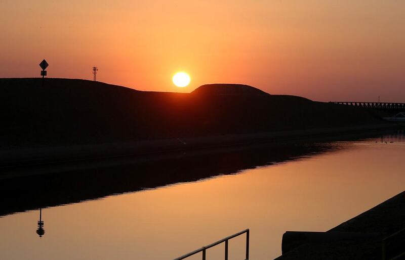 The sun rises over the Delta-Mendota Canal in Los Banos, California. The US Bureau of Reclamation officials announced that they will not be providing Central Valley farmers with any water from the federally run system of reservoirs and canals fed by mountain runoff. Justin Sullivan / Getty Images / AFP