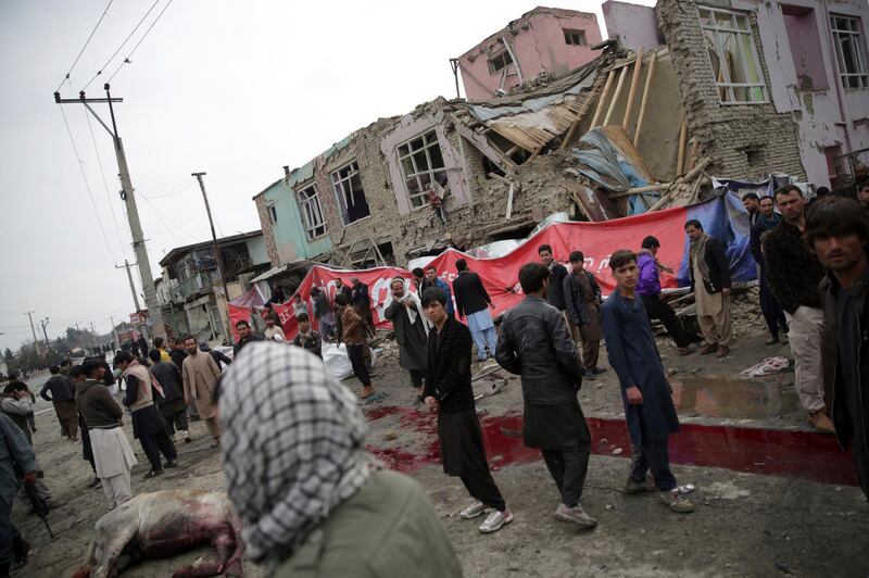 Residents walk through the site of a suicide attack in Kabul, Afghanistan, Friday, March 2, 2018. A large explosion in the eastern part of the Afghan capital on Friday morning killed at least one person and wounded six people an Afghan official said. (AP Photo/Massoud Hossaini)