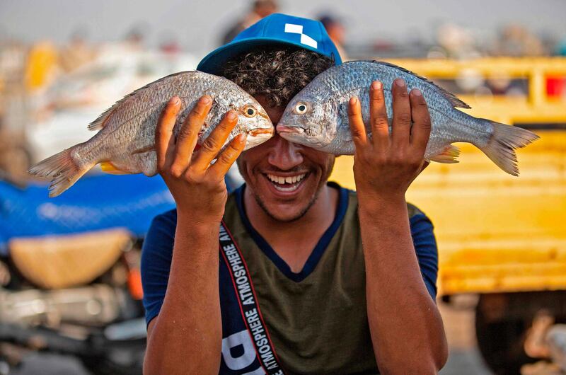 A youth plays with fish in Iraq’s southern port city of Al Faw, 90 kilometres south of Basra. In Iraq, a national lockdown to halt the spread of coronavirus has had an unexpected positive effect. Local businesses including fishermen no longer have to compete with cheap imports from the likes of Turkey and Iran. AFP