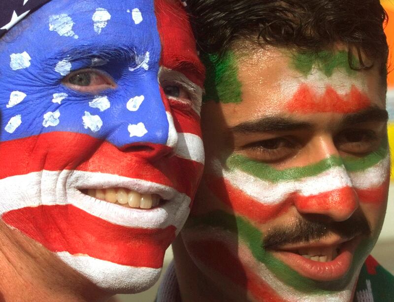 FILE - Mike Moscrop, left, from Orange County, Calif. , poses with Amir Sieidoust, an Iranian supporter living in Holland outside the Gerlain Stadium in Lyon, June 21, 1998, before the start of the USA vs Iran World Cup soccer match.  Iran defeated the U. S.  2-1 for its first World Cup win, eliminating them after just two games.  A rematch between the U. S.  and Iran will be played, Tuesday, Nov.  29, 2022.  (AP Photo / Jerome Delay)