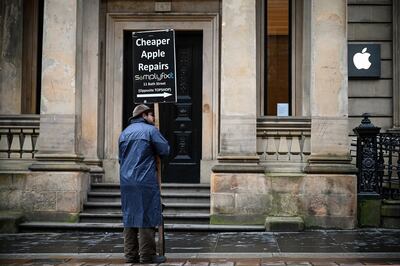 GLASGOW,  - MARCH 18: A man stands outside the closed Apple Mac store in Buchanan Street on March 18, 2020 in Glasgow, Scotland. People have been asked to work from home and socially distance themselves due to the coronavirus (COVID-19) pandemic. (Photo by Jeff J Mitchell/Getty Images)