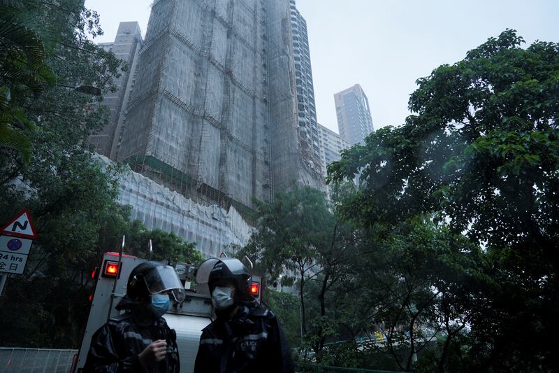 Police officers near collapsed scaffolding in Hong Kong. Reuters