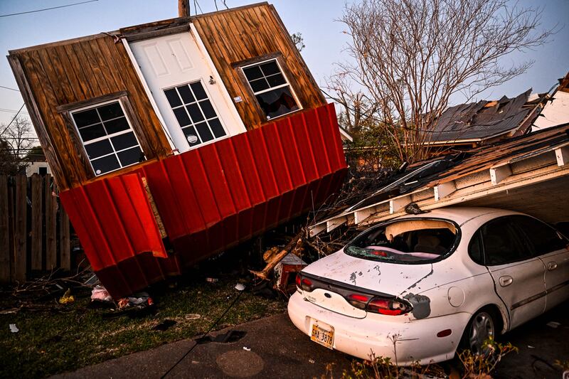 The remains of crushed house and cars are seen in Rolling Fork, Mississippi, on March 25, 2023, after a tornado touched down in the area.  - At least 25 people were killed by devastating tornadoes that ripped across the southern US state of Mississippi, tearing off roofs, smashing cars and flattening entire neighborhoods, with the region readying for more severe weather Sunday. 
The powerful weather system, accompanied by thunderstorms and driving rain, cut a path of more than 100 miles (60 kilometers) across the state late March 24, 2023, slamming several towns along the way.  (Photo by CHANDAN KHANNA  /  AFP)