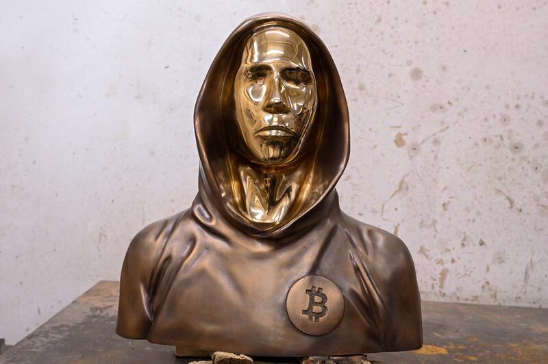 A bronze statue of Satoshi Nakamoto, the mysterious inventor of virtual currency bitcoin, is pictured in the foundry at the village of Nagytarcsa, east of Budapest on September 10, 2021.  - Hungarian bitcoin enthusiasts unveiled a statue on September 16, 2021 in Budapest that they say is the first in the world to honour Satoshi Nakamoto, the mysterious inventor of the virtual currency.  The bronze life-size sculpture depicts a hooded figure with stylised facial features, alluding to Nakamoto, a pseudonym credited as bitcoin's founder, but whose identity remains unknown.  (Photo by ATTILA KISBENEDEK  /  AFP)  /  RESTRICTED TO EDITORIAL USE - MANDATORY MENTION OF THE ARTIST UPON PUBLICATION - TO ILLUSTRATE THE EVENT AS SPECIFIED IN THE CAPTION