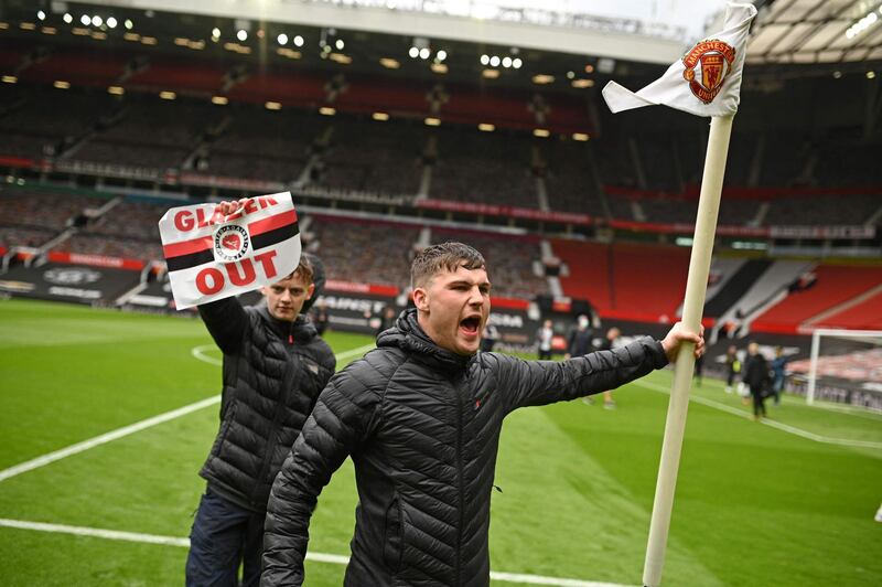 Manchester United supporters on the Old Trafford pitch before the game against Liverpool. AFP