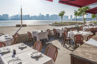 The outdoor terrace at La Petite Maison Abu Dhabi has water views. Courtesy Romain Legrand