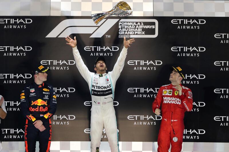 Lewis Hamilton, centre, celebrates on the podium after winning the 2019 Abu Dhabi Grand Prix. AP Photo