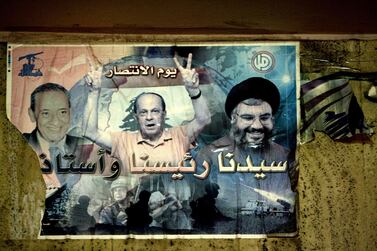 A 2011 photo shows a poster in Beirut of Lebanese opposition leaders, Parliament Speaker Nabih Berri, left, then MP Michel Aoun, centre, and Hezbollah chief Hassan Nasrallah. AFP