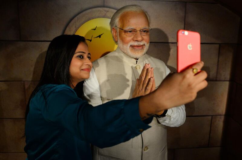 A visitor takes a selfie with a waxwork of Indian prime minister Narendra Modi at Madame Tussauds Delhi in New Delhi. Sajjad Hussain / AFP